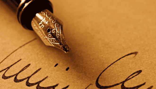 Gold pen signing a name.