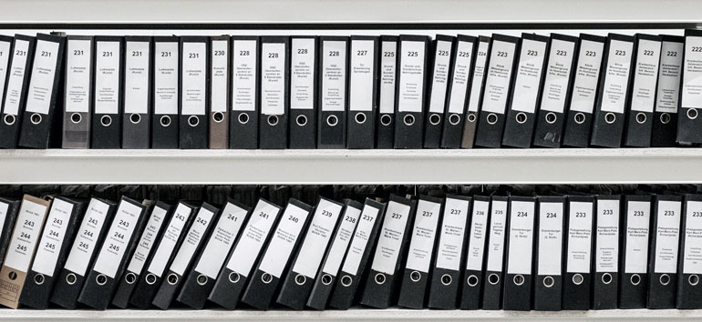 shelf containing numerous binders