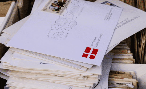 Pile of letters with Danish flag stamp.