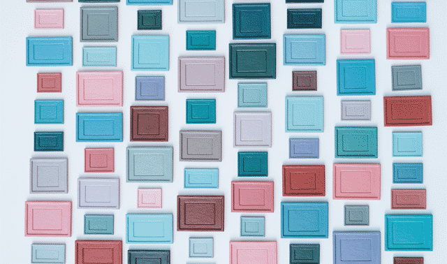 A grid of rectangular shapes of varying sizes and colors, including shades of blue, pink, purple, and green, arranged on a light background.