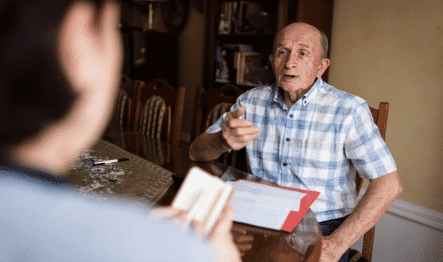 Person asking interview questions to an elderly family member.