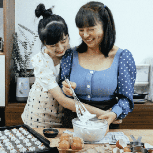 Woman and daughter cooking together.