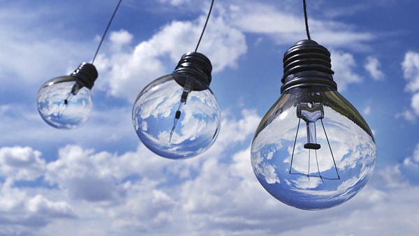 lightbulbs hanging in front of blue sky