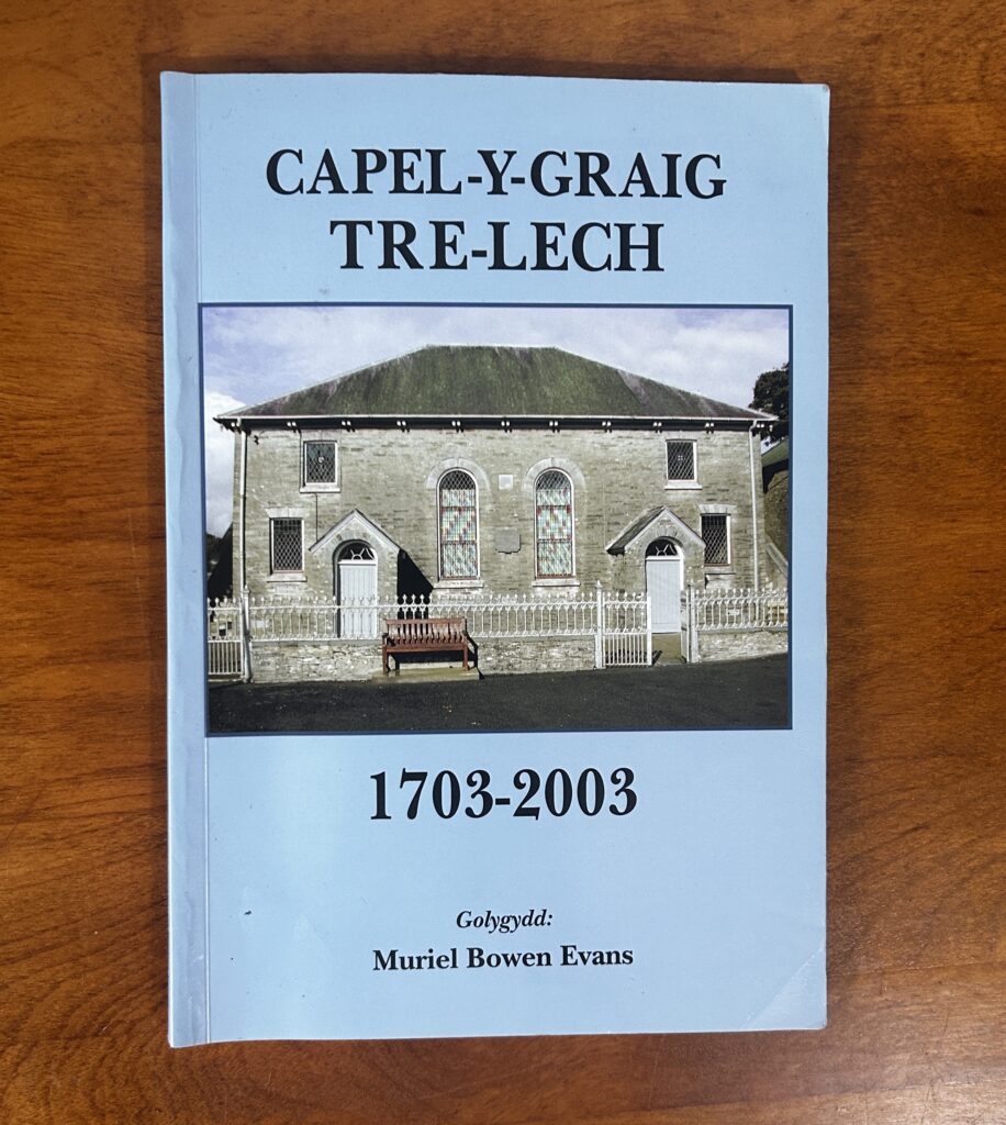 Book cover titled “Capel-Y-Graig Tre-Lech 1703-2003” by Muriel Bowen Evans with a photo of a chapel on a blue background.
